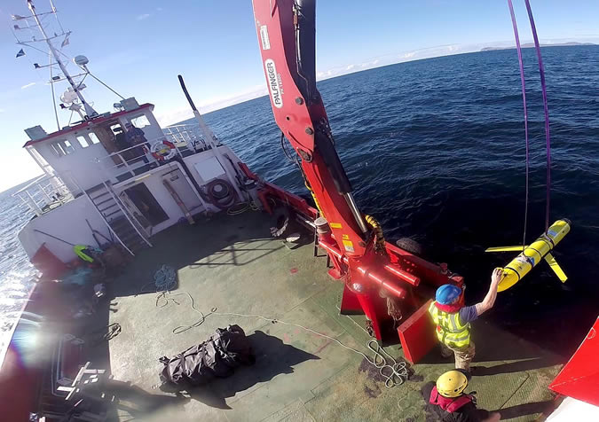 Submarine glider being recovered by Royal Navy personnel off the Outer Hebrides